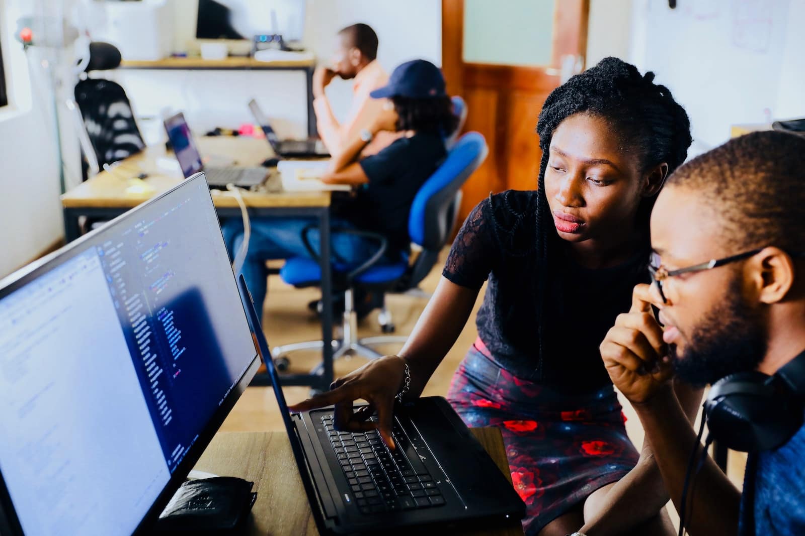 group of people discussing as they read a monitor